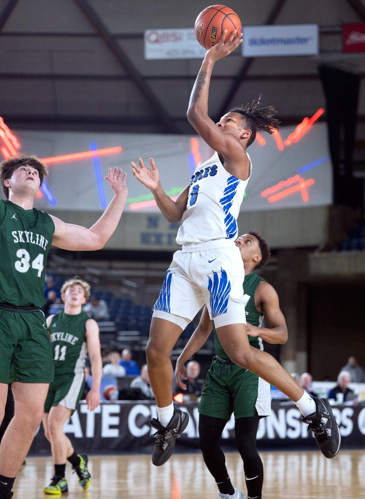 Federal Way’s Vaughn Weems flies to the basket in front of Skyline defender Willy Heise during their state quarterfinal game at the WIAA state basketball tournament in the Tacoma Dome in Tacoma, Washington, on Wednesday, March 1, 2023. Federal Way won the game, 69-53.