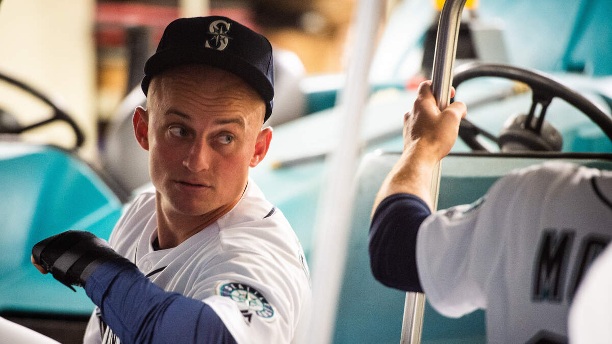 Mariners third baseman Kyle Seager speaks with teammate as they are loaded into a cart to make their way to the tunnel. The Seattle Mariners played the Boston Red Sox in a Major League Baseball game at T-Mobile Park in Seattle, Wash., on Thursday, March 28, 2019.