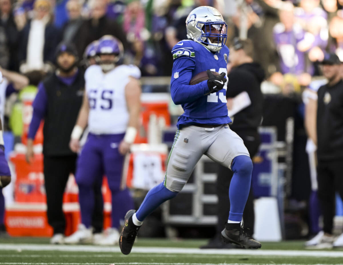 Seattle Seahawks linebacker Ernest Jones IV (13) returns an interception 85 yards for a touchdown during the second quarter of the game against the Minnesota Vikings at Lumen Field, on Sunday, Nov. 30, 2025, in Seattle.