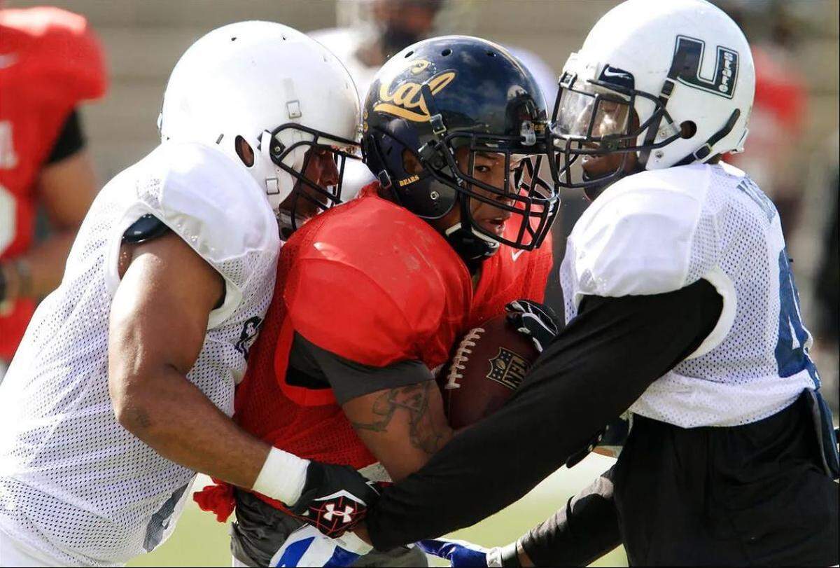Utah State linebacker Bobby Wagner (right, 45 in white) tackles California wide receiver Marvin Jones at practice for the Senior Bowl in Mobile, Alabama, Jan. 25, 2012. The Seahawks drafted Wagner a few months later.