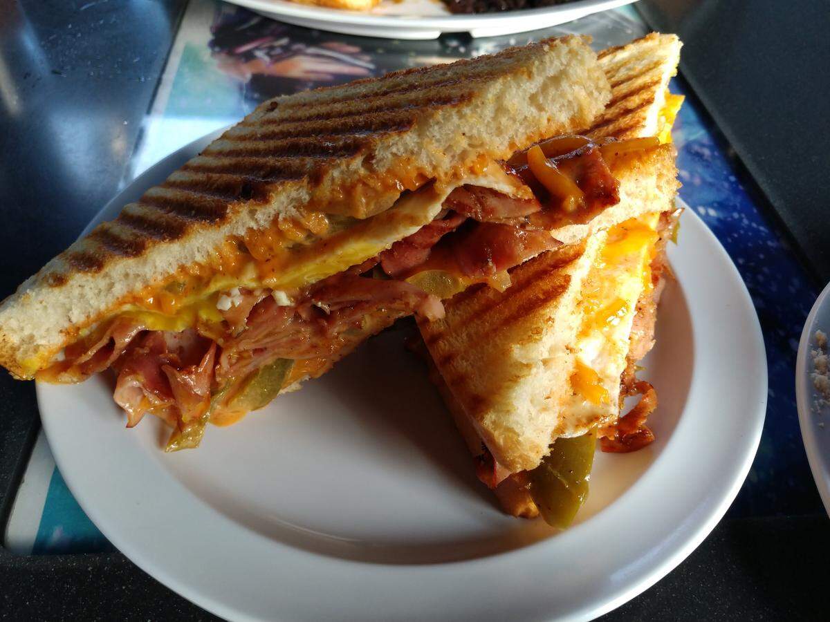 This breakfast sandwich with ham, an egg and chipotle aioli is served at The Church Cantina.