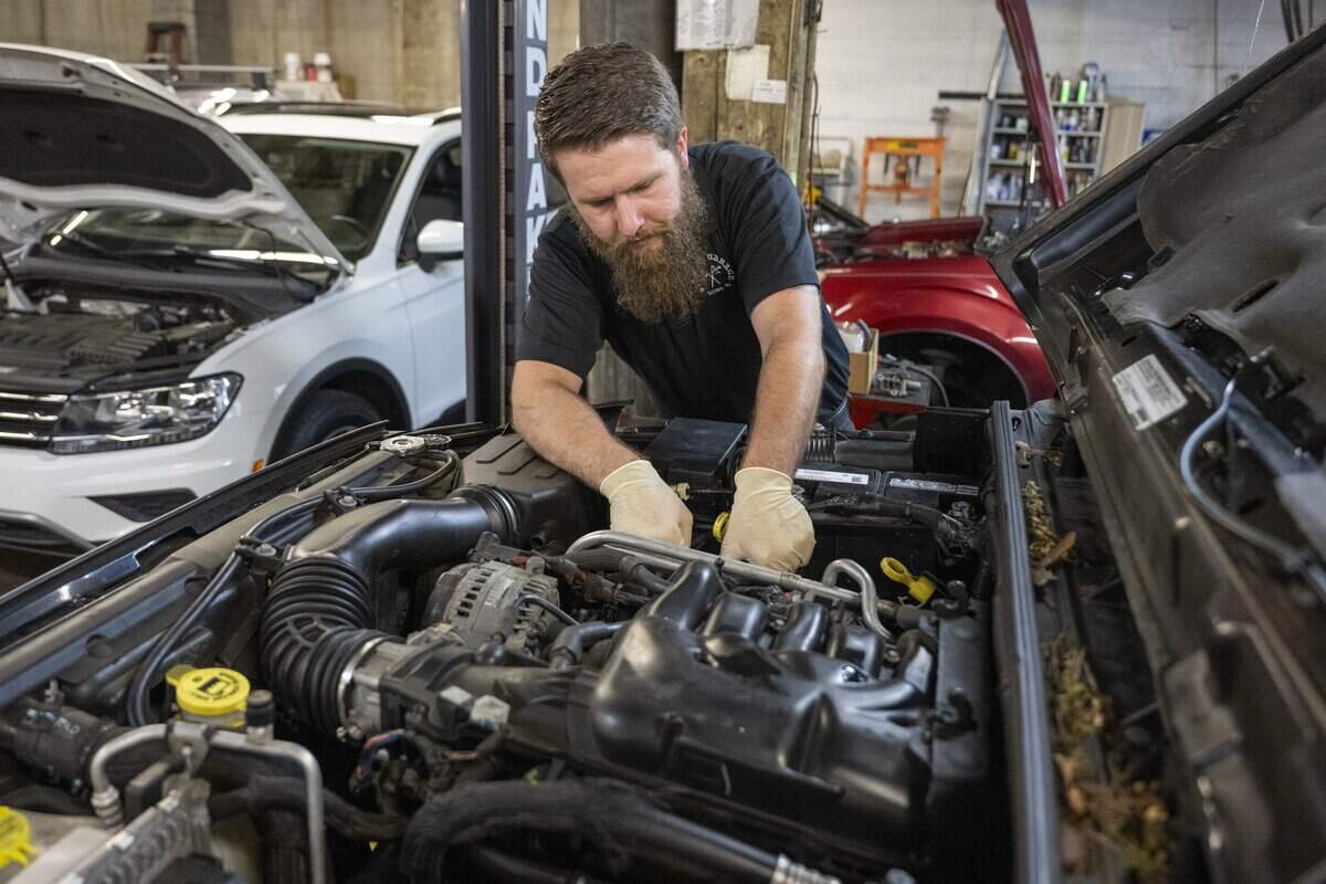 Stadium Garage owner Quentin Luthi works to diagnose a cylinder misfire on Monday, June 29, 2026, in Tacoma, Wash. Stadium Garage operates below Ball Auto, where Luthi used to work.