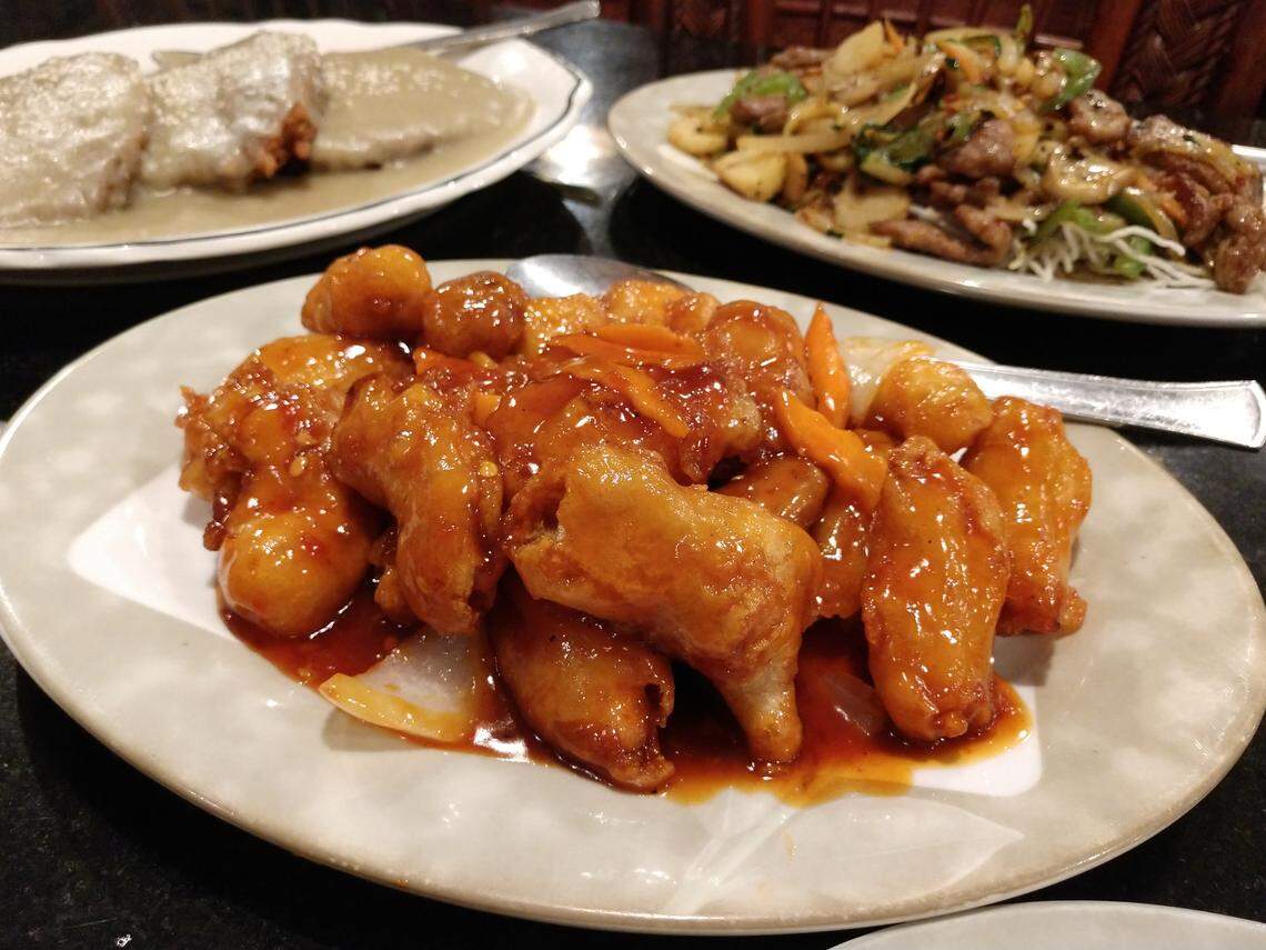 General Tso’s chicken (front), almond fried chicken (back left) and Mongolian beef (back right) from Dragon Ball Chinese restaurant in downtown Sumner.