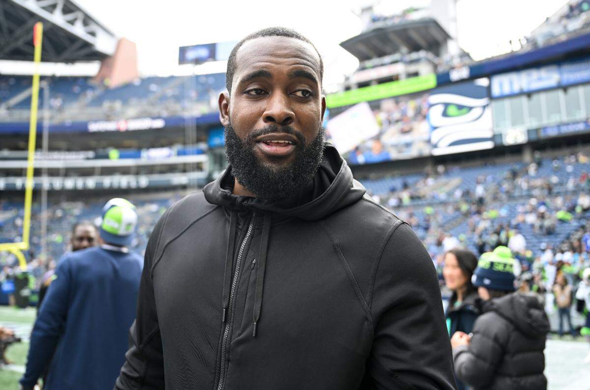Kam Chancellor, safety on the Super Bowl Champion Seahawks signs autographs before the game between the Seattle Seahawks and the Carolina Panthers at Lumen Field, Sunday, Sept. 24, 2023, Seattle, Wash.