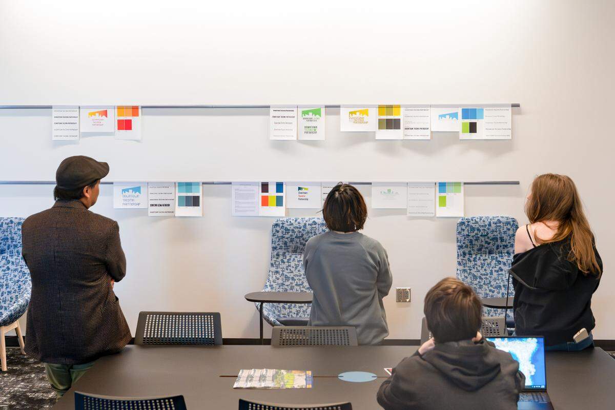 A class gathers to discuss graphic designs in an open work space of the new Center for Innovative Learning and Engagement at Tacoma Community College on Wednesday, April 23, 2025.