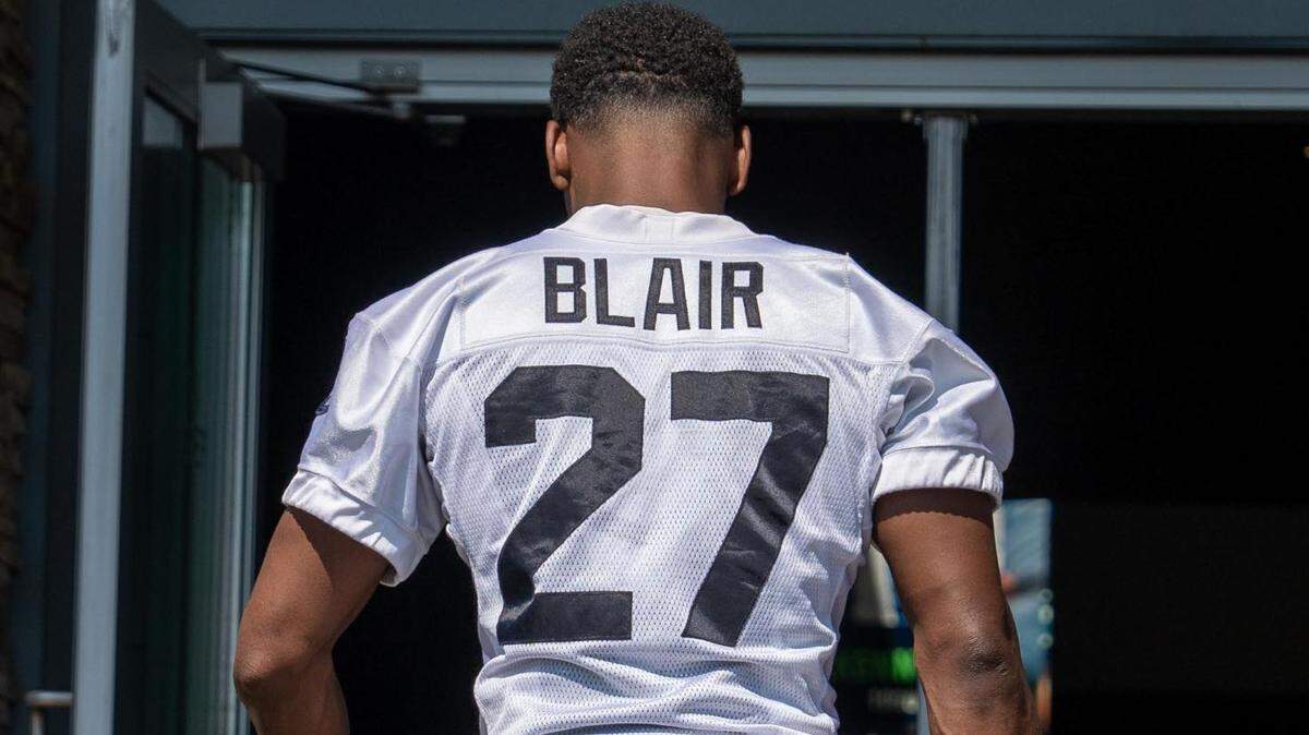 Seattle Seahawks free safety Marquise Blair and his son walk to the locker room after the second day of Seahawks training camp at the Virginia Mason Athletic Center in Renton, Wash. on July 28, 2022.