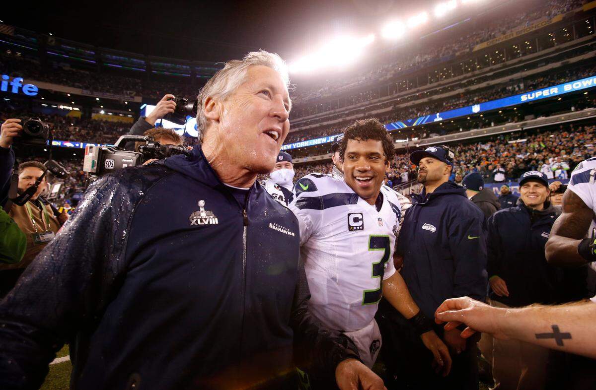 Seattle head coach Pete Carroll and quarterback Russell Wilson celebrate in the final seconds of the Seahawks 43-8 victory over the Denver Broncos in Super Bowl XLVII at MetLife Stadium in East Rutherford, New Jersey, on Sunday, Feb. 2, 2014.