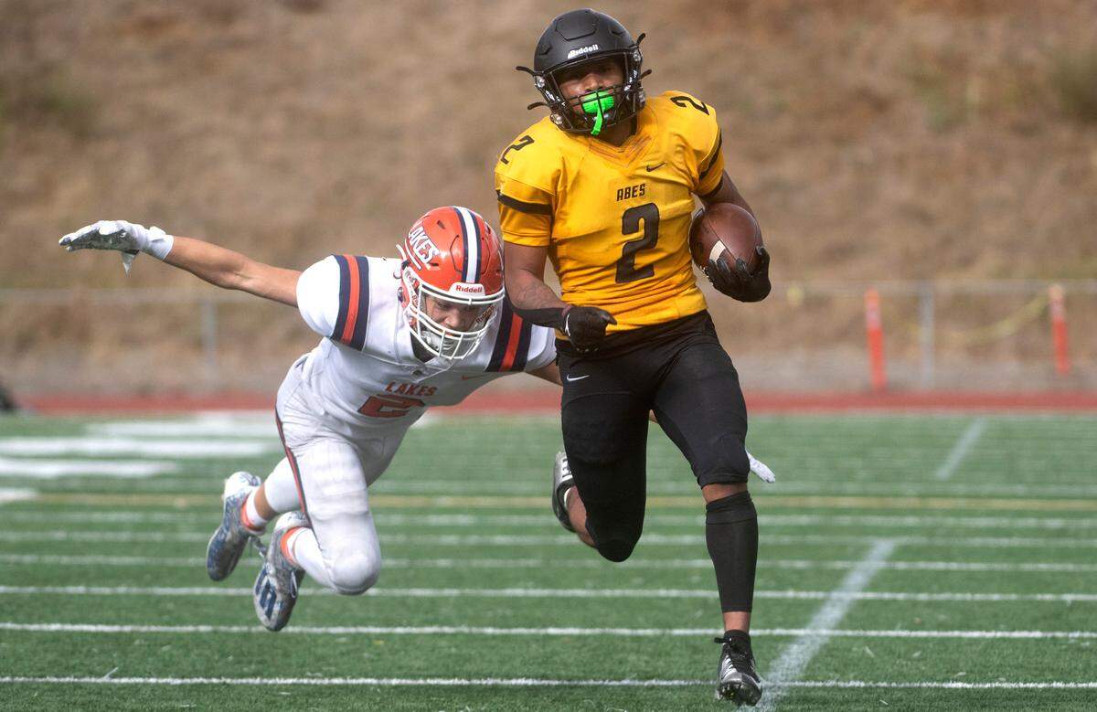 Lincoln kickoff returner Darke Granberry is chased down by Lakes defender E’lijian McChristian during Saturday afternoon’s football game at Lincoln Bowl in Tacoma, Washington, on Oct. 22, 2022.