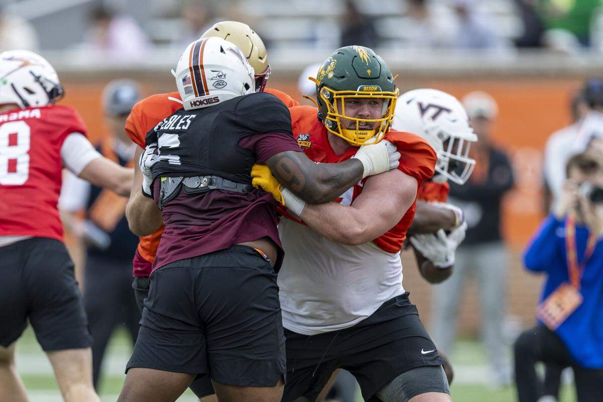 Jan 30, 2025; Mobile, AL, USA; National team defensive lineman Aeneas Peebles of Virginia Tech (16) battles National team offensive lineman Grey Zabel of North Dakota State (77) during Senior Bowl practice for the National team at Hancock Whitney Stadium. Mandatory Credit: Vasha Hunt-Imagn Images