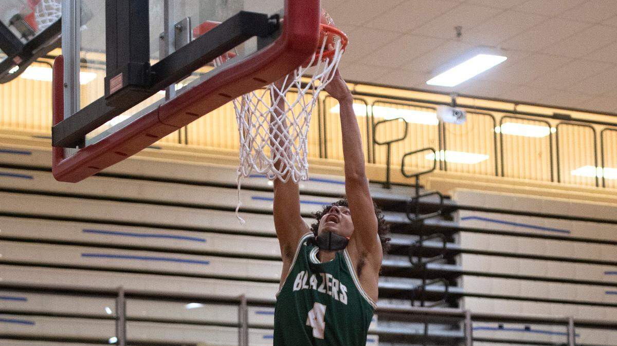 Timberline’s Brooklyn Hicks throws down a dunk in front of Capital defenders Cooper Carlson (24) and Austin Morales during Thursday night’s 3A SSC league boys basketball game at Capital High School in Olympia, Washington, on Friday, June 11, 2021.