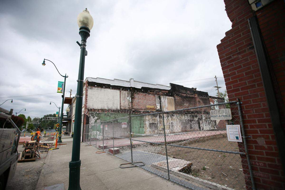 An empty space filled with dirt and cement sits on Sumner’s Main Street on Wednesday, May 31, 2023. The building that used to be there housed Stuck Junction Saloon, Whispering Hills Market and The Attic.