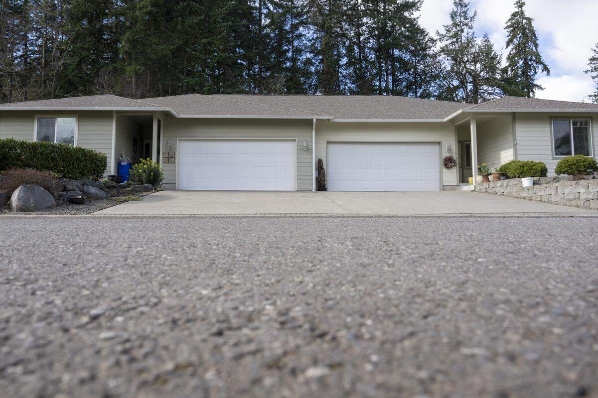 A home where a car was parked before reported stabbings left five people dead is pictured on Wednesday, Feb. 25, 2026, on the 14000 block of 87th Avenue Court Northwest on the Key Peninsula.