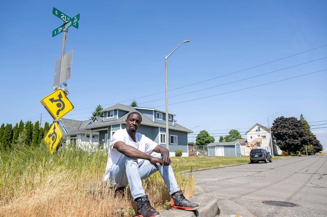 Ivory Kelly sits on a round-about outside the front of the house were he grew up and had recently been parking his RV — which was also where he was living — along South 21st Street in the Hilltop neighborhood in Tacoma, Wash., on Monday, May 29, 2023. Kelly had his RV towed an impounded earlier this year. While impounded the RV was ransacked and he lost nearly all of his his possessions.