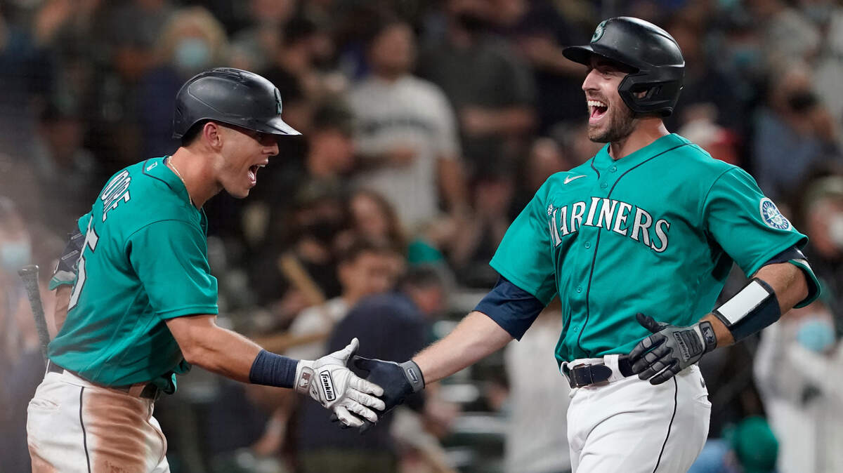 Seattle Mariners’ Tom Murphy, right, is greeted by Dylan Moore after Murphy hit a solo home run during the sixth inning of the team’s baseball game against the Arizona Diamondbacks, Friday, Sept. 10, 2021, in Seattle. The homer was Murphy’s second in the game. (AP Photo/Ted S. Warren)