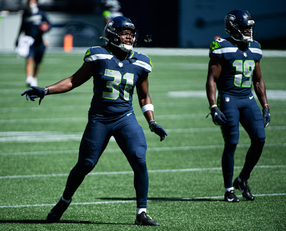 Running back DeeJay Dallas dances on the field during warmups. The Seattle Seahawks played a mock game at CenturyLink Field in Seattle, Wash., on Wednesday, Aug. 26, 2020.