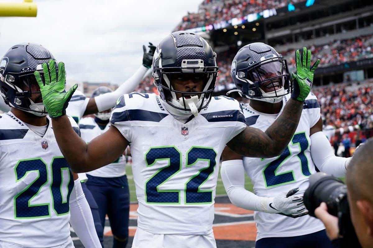 Seattle Seahawks’ Tre Brown (22) celebrates an interception during the second half of an NFL football game against the Cincinnati Bengals, Sunday, Oct. 15, 2023, in Cincinnati. (AP Photo/Carolyn Kaster)