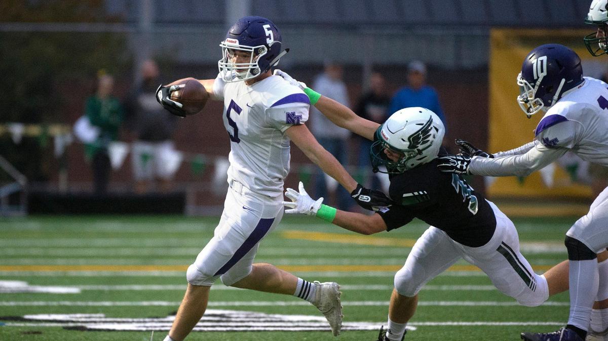 North Thurston running back Jase Marcott tries to break away from Peninsula defender Ben Goins during Thursday night’s 3A SSC league opener football game at Roy Anderson Field in Gig Harbor on Sept. 19, 2019.