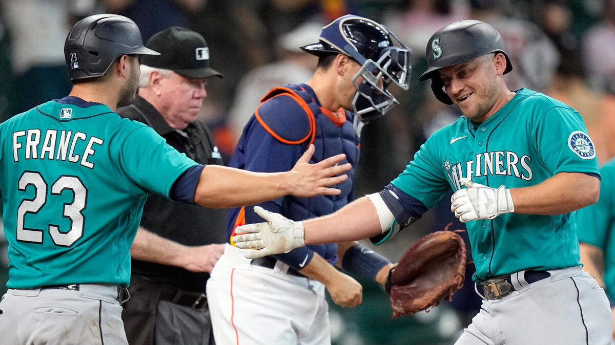 Seattle Mariners’ Kyle Seager, right, celebrates with Ty France (23) after both scored on Seager’s three-run home run against the Houston Astros during the 11th inning of a baseball game Sunday, Aug. 22, 2021, in Houston. (AP Photo/David J. Phillip)