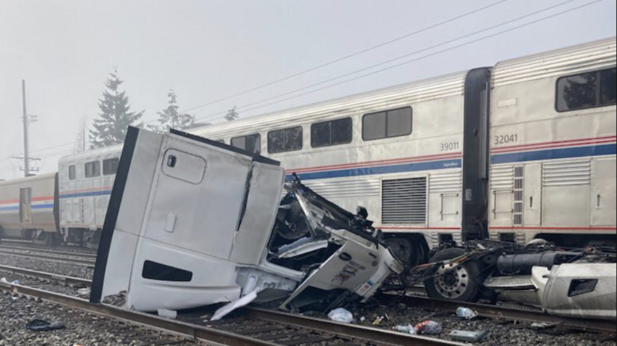 A truck that found itself stuck on railroad tracks in Auburn was hit by a southbound Amtrak train on Saturday. The driver was able to escape with no injuries.