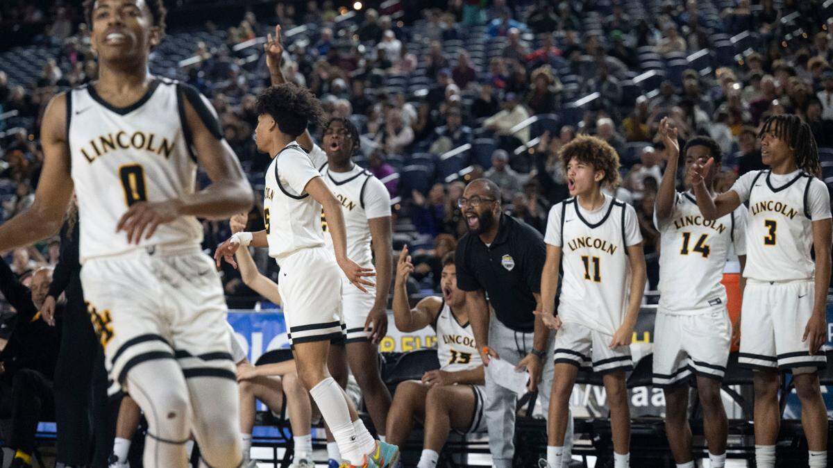 Lincoln’s Uriah Wilson (5) celebrates in front of the Abes’ bench after scoring a 3-pointer in the fourth quarter of a Class 3A state basketball tournament first-round game against Federal Way at the Tacoma Dome on Wednesday, March 5, 2025, in Tacoma, Wash.