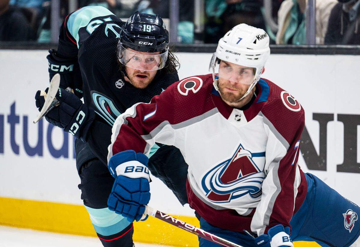 Seattle Kraken left wing Jared McCann (19) tries to defend Colorado Avalanche defenseman Devon Toews (7) during the first period of a first round 2023 Stanley Cup Playoffs game against the Colorado Avalanches at Climate Pledge Arena in Seattle on Saturday, April 22, 2023.