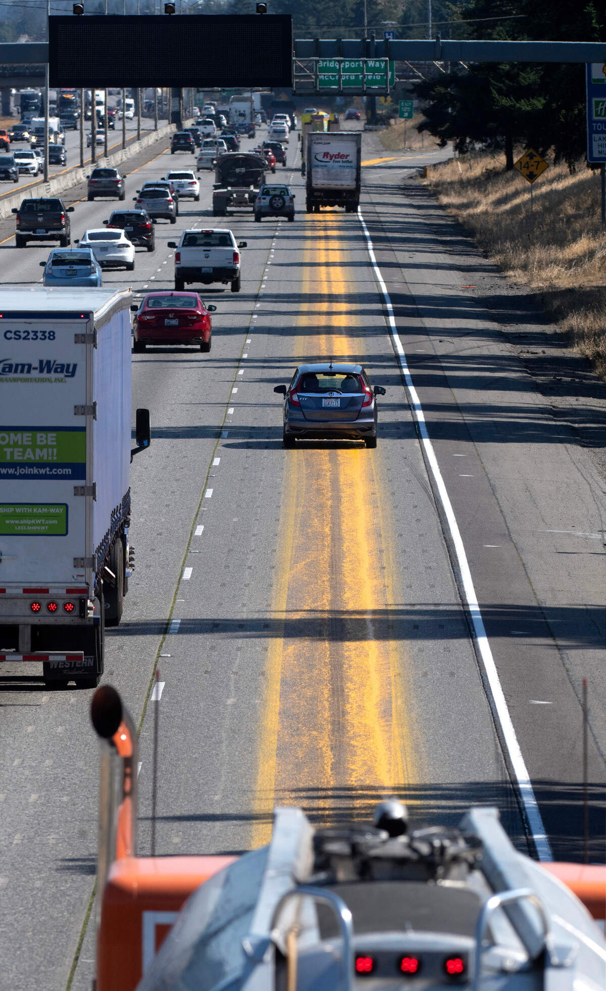 Spilled yellow paint fills the right-hand lane of northbound Interstate 5 through Lakewood, Washington, on Tuesday, Aug. 15, 2023.