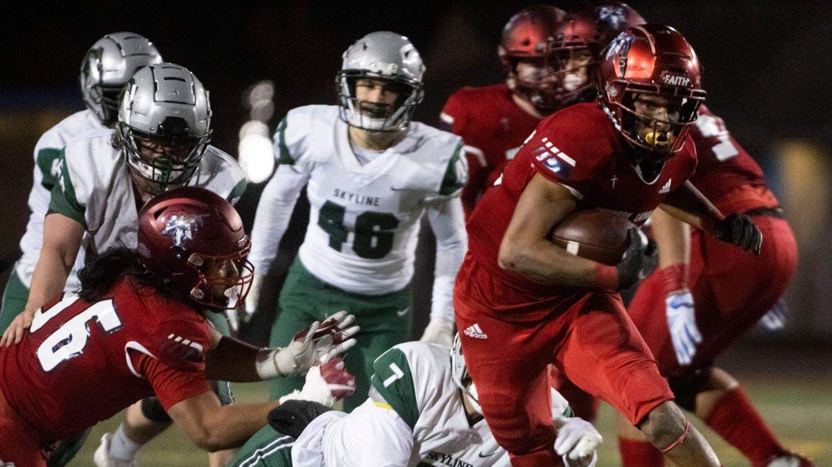 Kennedy Catholic running back Xe’Ree Alexander breaks through a tackle attempt by Skyline’s Nathan Fischer on his way to a rushing touchdown in the second quarter of a Class 4A state quarterfinal game on Friday, Nov. 18, 2022, at Highline Memorial Stadium in Burien, Wash.