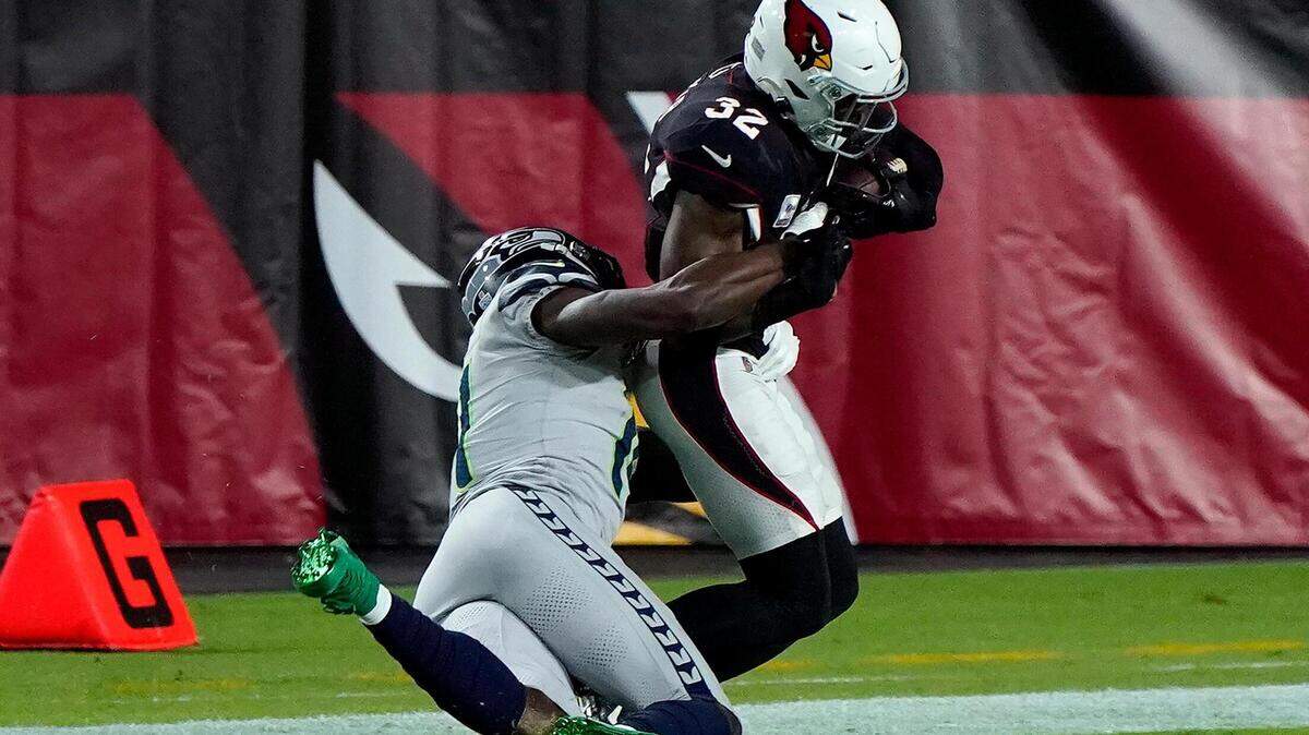 Seattle Seahawks wide receiver DK Metcalf tackles Arizona Cardinals strong safety Budda Baker (32) short of the goal line after Baker intercepted a pass during the first half of an NFL football game, Sunday, Oct. 25, 2020, in Glendale, Ariz. (AP Photo/Rick Scuteri)
