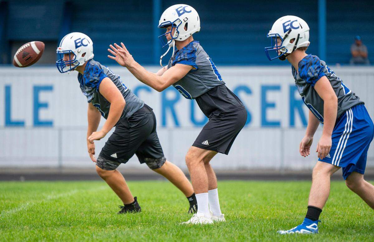 Eatonville Cruisers quarterback Job Kralik (15) receives a snap during a play while practicing at Eatonville High School in Eatonville Wash. on August 20, 2022.
