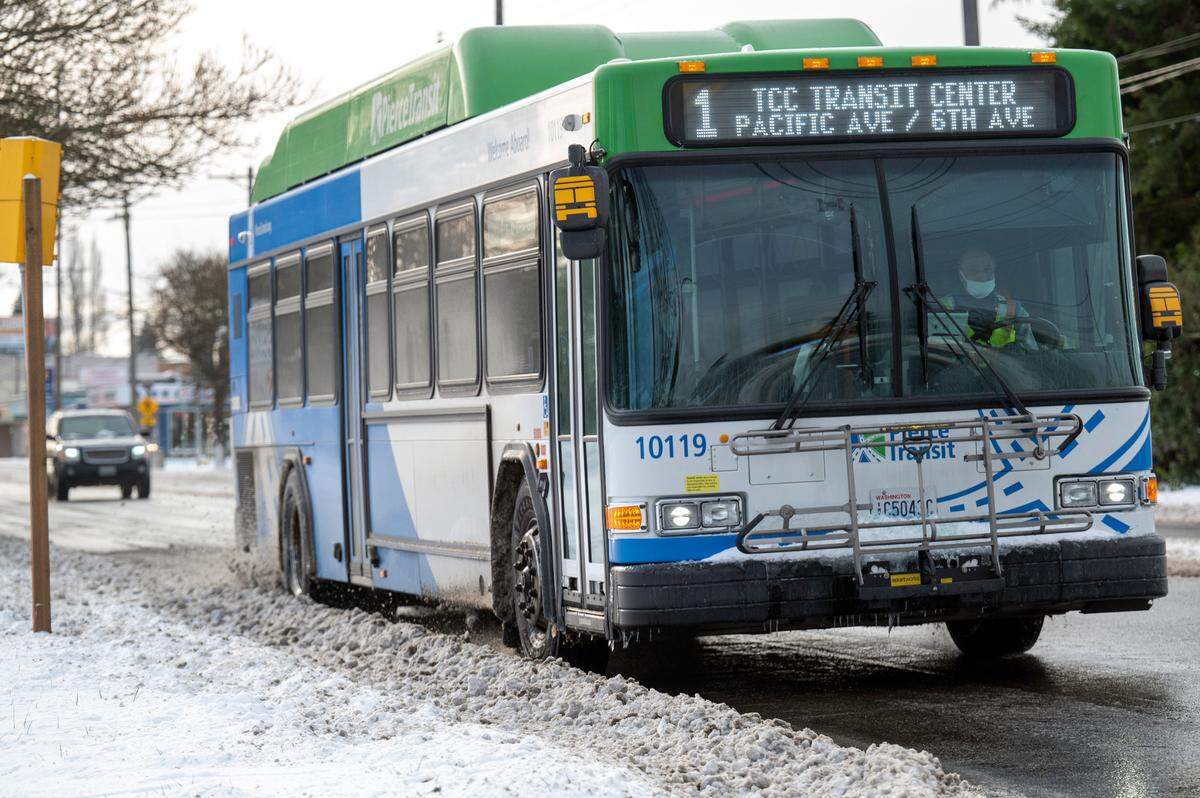 A Pierce Transit bus drives north of Pacific Avenue on Monday afternoon. Pierce Transit is providing free bus rides to those heading to shelters and warming centers during the cold temperatures and snow.