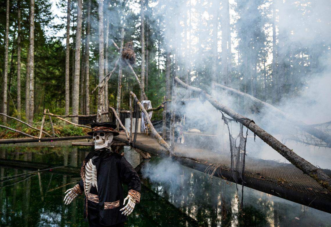 A fog machine fills the air with fog as a fake skeleton stands in a pond along the mile long trail at My Haunted Forest at Grand Farms in Vaughn, Wash. on Oct. 23, 2022.