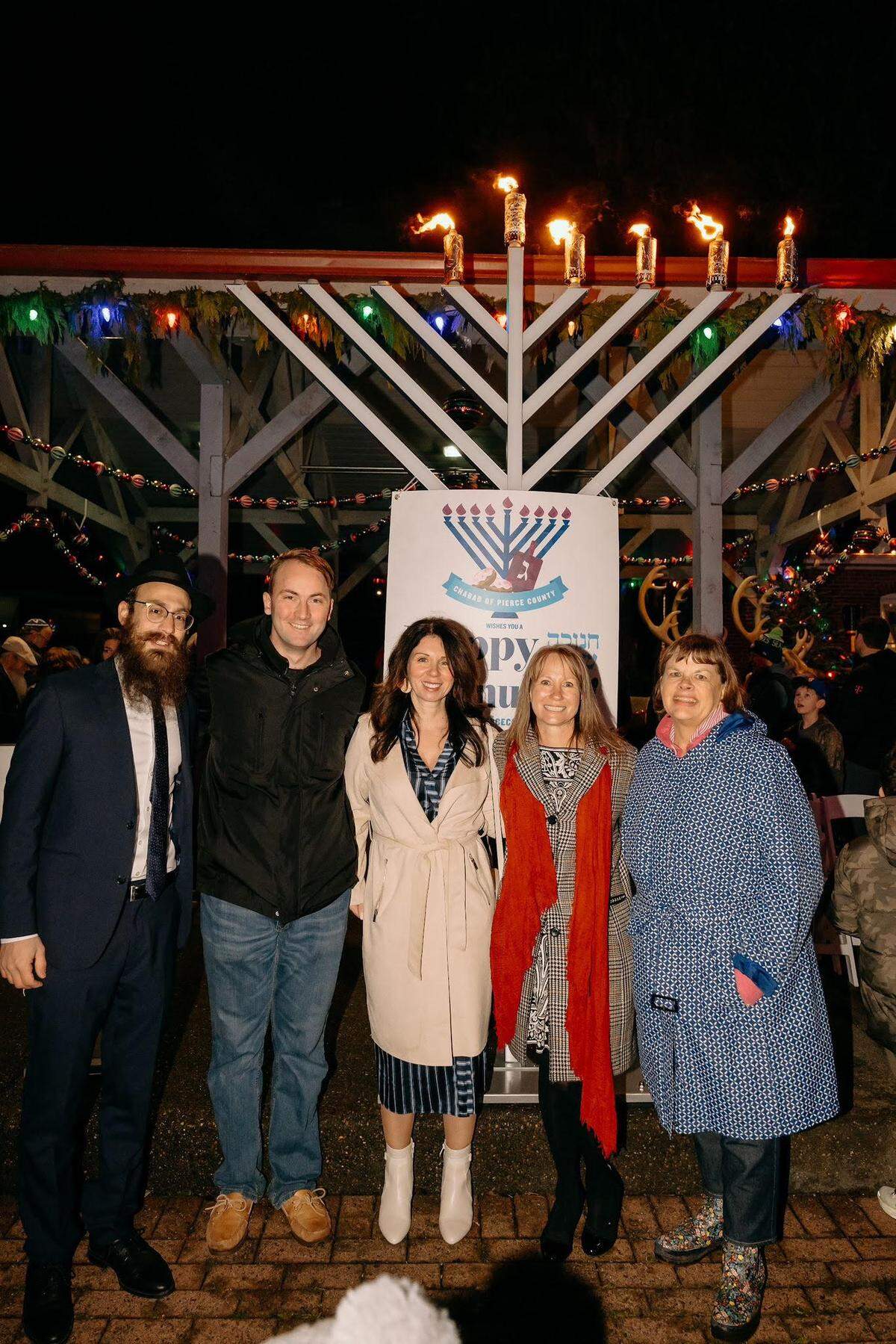 (Left to right) Rabbi Mendel Kesselman, incoming state Rep. Adison Richards, state Rep. Michelle Caldier, Pierce County Council member Robyn Denson and Gig Harbor Mayor Mary Barber attended the public menorah lighting led by Chabad of Pierce County at Skansie Brothers Park Sunday, Dec. 29, 2024.