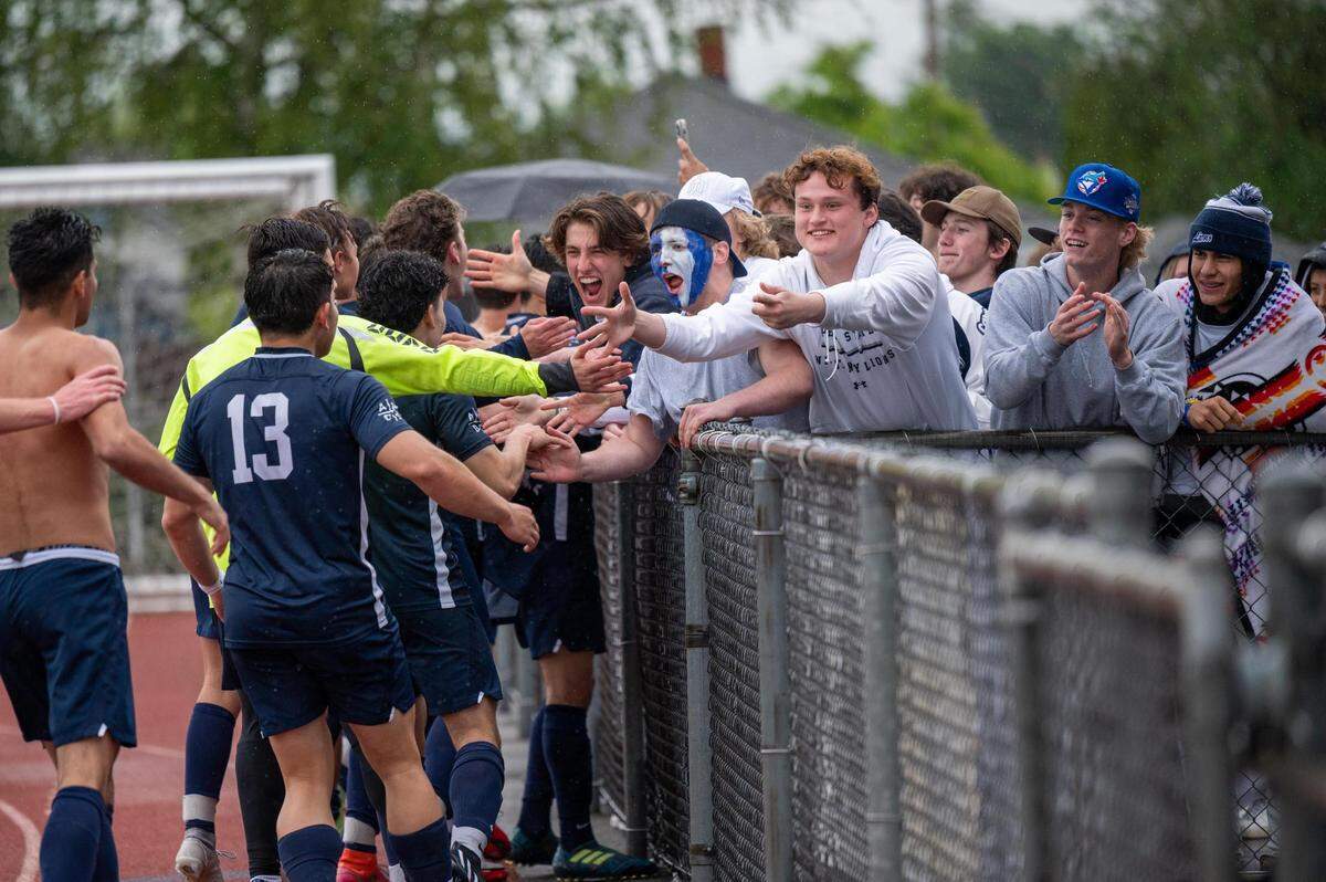 The Bellarmine boys soccer team runs to the crowd celebrating their 4A State Championship win at Sparks Stadium in Puyallup, WA., on Saturday May 28, 2022.