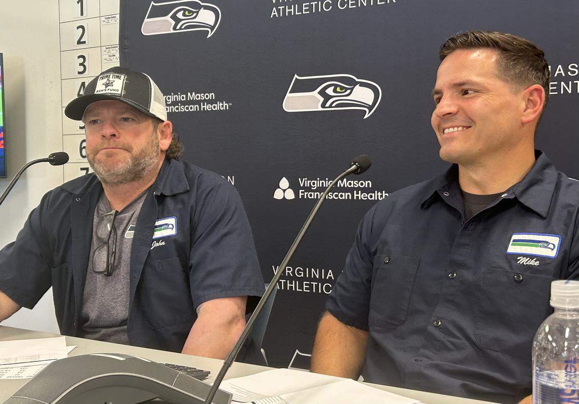 General manager John Schneider (left) and coach Mike Macdonald speak inside the Seattle Seahawks' Virginia Mason Athletic Center in Renton Saturday, April 25, 2026, after they selected eight players in the NFL draft.