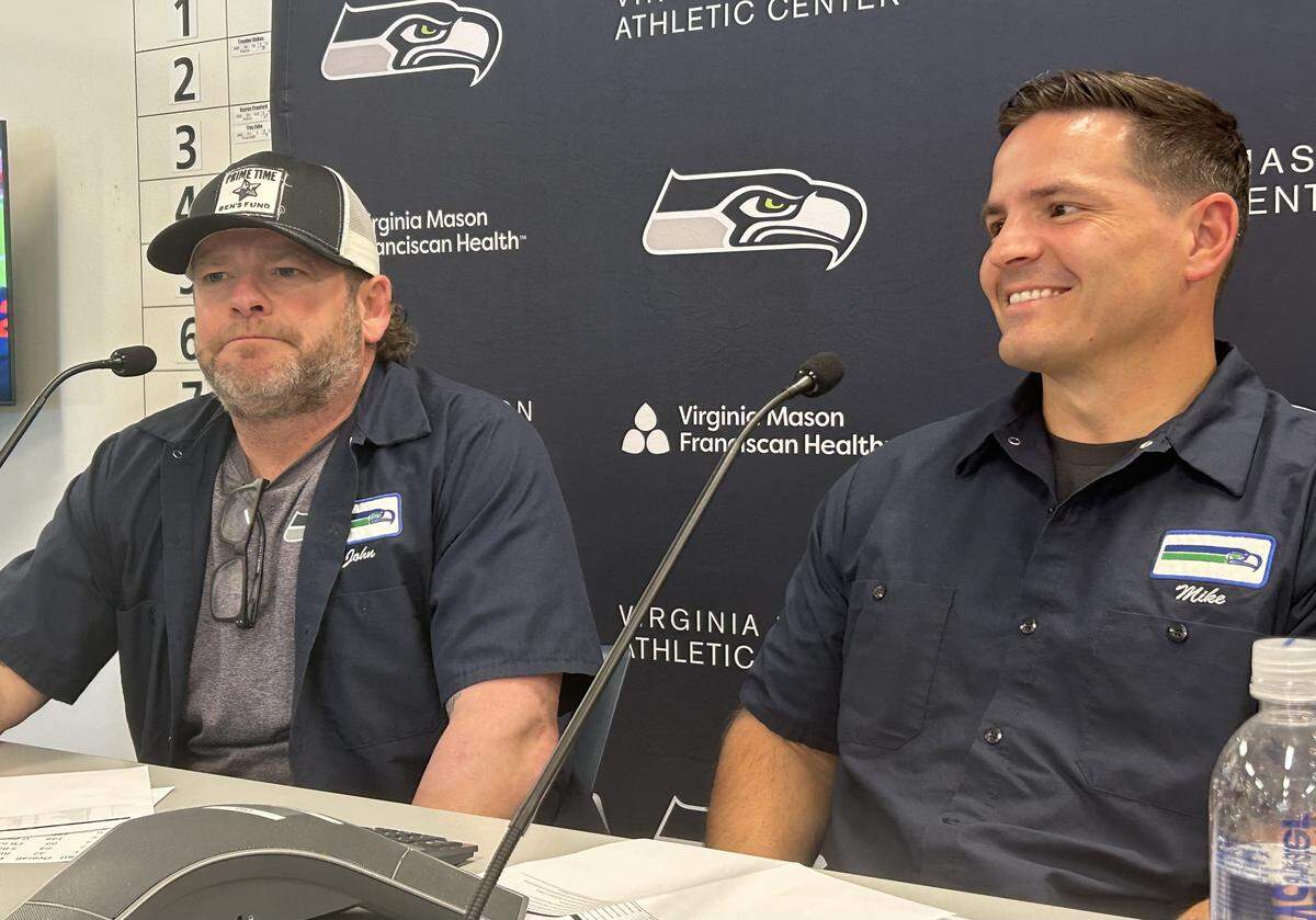 General manager John Schneider (left) and coach Mike Macdonald speak inside the Seattle Seahawks' Virginia Mason Athletic Center in Renton Saturday, April 25, 2026, after they selected eight players in the NFL draft.