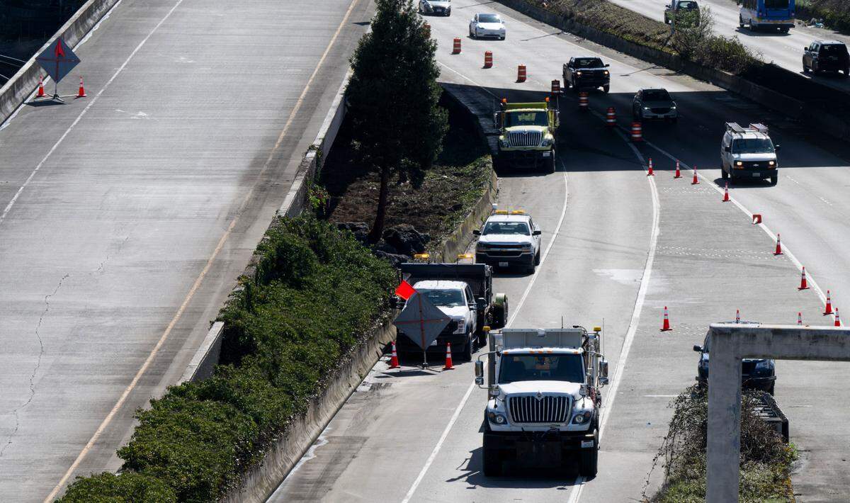 Crews block the onramp to Interstate 705 while installing boulders under a overpass, on Tuesday, March 25, 2025, in Tacoma, Wash.