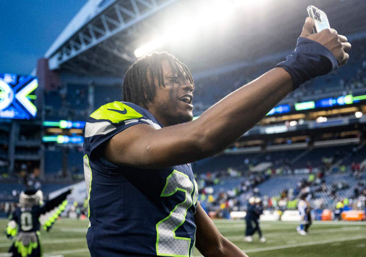 Seattle Seahawks cornerback Tariq Woolen (27) talks on the phone after defeating the Los Angeles Rams in overtime after an NFL game at Lumen Field in Seattle, Wash. on Jan. 8, 2023. The Seahawks defeated the Rams in overtime 19-16.