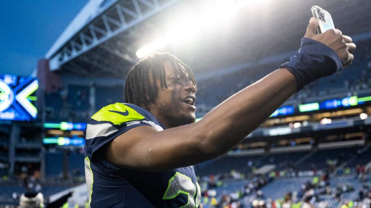 Seattle Seahawks cornerback Tariq Woolen (27) talks on the phone after defeating the Los Angeles Rams in overtime after an NFL game at Lumen Field in Seattle, Wash. on Jan. 8, 2023. The Seahawks defeated the Rams in overtime 19-16.