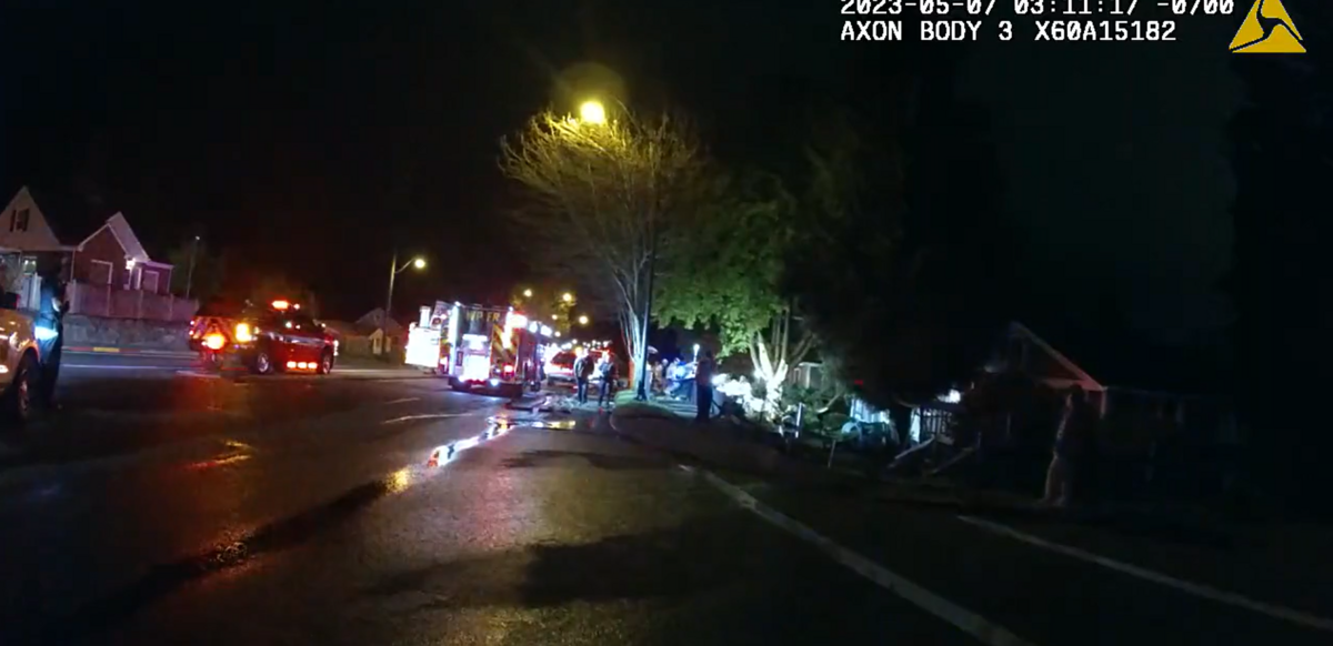 A still image from body-camera footage shows emergency responders working the scene of a fatal single-car crash that occurred Sunday, May 7, 2023 in the 3100 block of Bridgeport Way West in University Place.