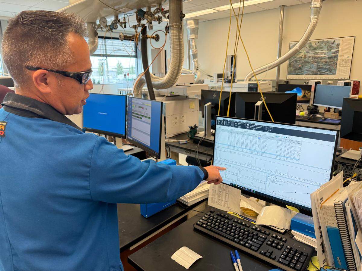 Center for Urban Waters environmental scientist Tom Chontofalsky demonstrates a liquid chromatography triple quadrupole mass spectrometry device that can detect PFAS.