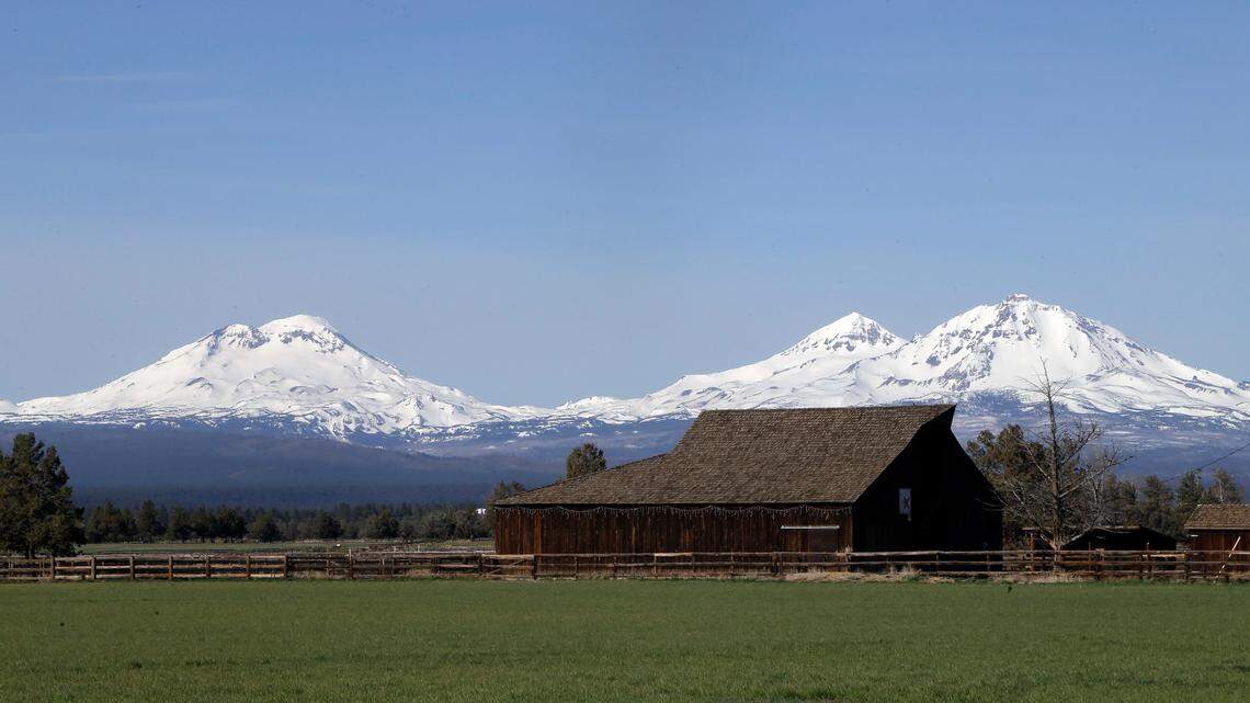 A 23-year-old climber injured after triggering a small avalanche on Oregon’s South Sister peak, seen at left in 2018, had to wait overnight for rescue, officials say.
