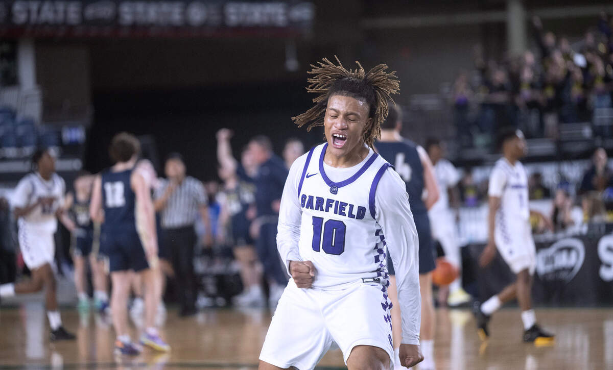 Garfield’s Marcel Jones celebrates as time expires in the Bulldogs’ 60-58 overtime victory over the Arlington Eagles during Wednesday morning’s opening-round game of the 3A boys state basketball tournament in the TacomaDome in Tacoma, Washington, on Wednesday, Feb. 28, 2024.