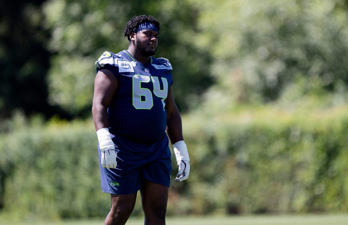 Seahawks rookie guard Christian Haynes (64) warms up during the first day of training camp at the Virginia Mason Athletic Center in Renton, July 24, 2024.