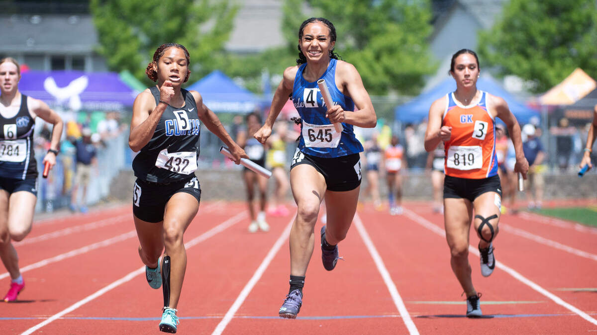 Curtis’ Lenice Walston (left) holds off a charge by Federal Way’s Cassandra Atkins to win the state title in the 4A girls 4x100 relay during the final day of the WIAA state track and field championships at Mount Tahoma High School in Tacoma, Washington, on Friday, May 26, 2023.