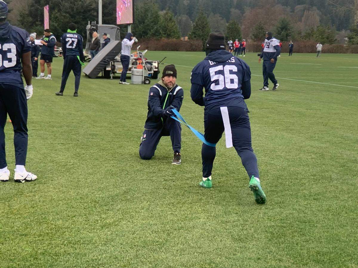 Jordyn Brooks stretches on the side of the practice field at the start of drills Friday, Jan. 5, 2024, two days before the Seahawks’ final regular-season game, at Arizona. The team listed Brooks questionable to play in the game because of an ankle injury. He missed Seattle’s loss to Pittsburgh Dec. 31, 2023.