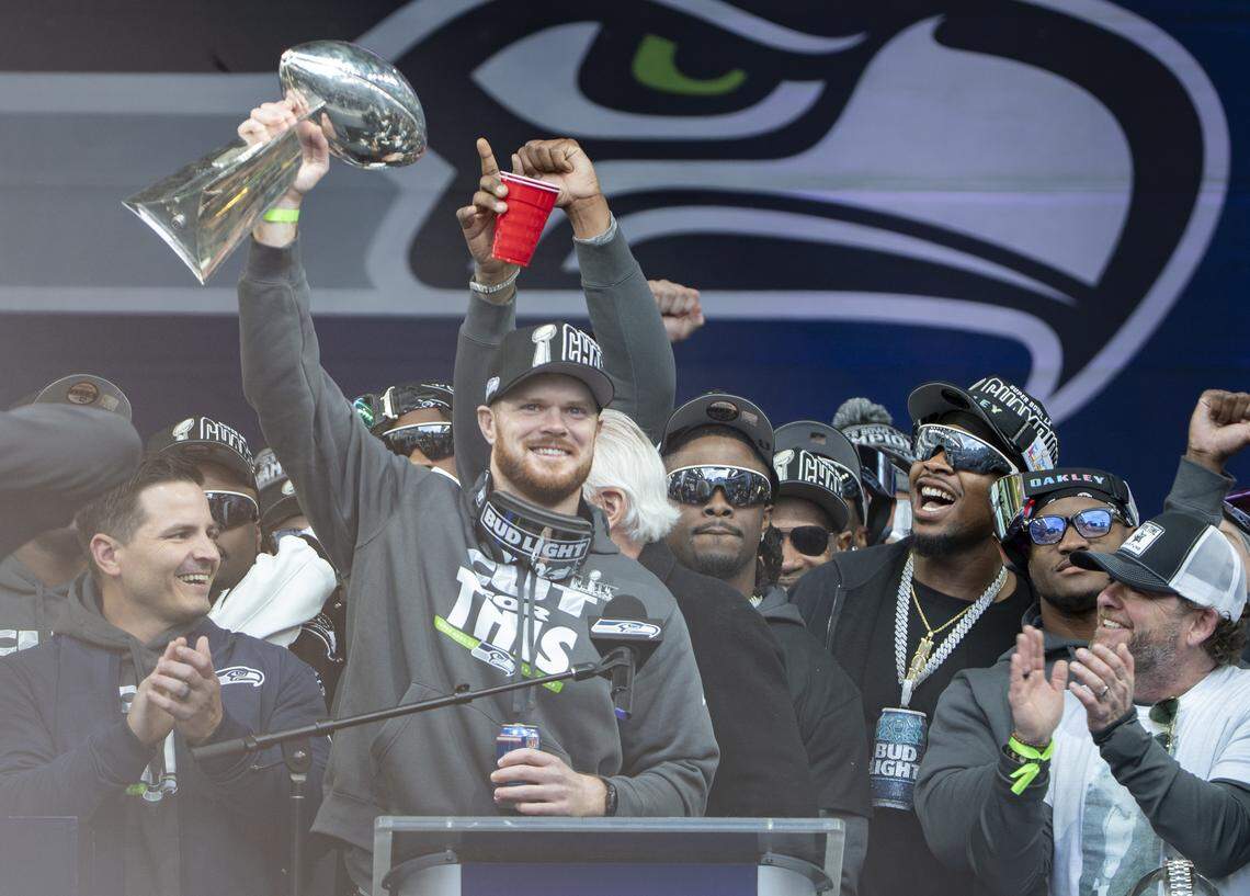 Seattle Seahawks quarterback Sam Darnold raises the Lombardi Trophy during the team’s Trophy Celebration event at Lumen Field on Wednesday, Feb. 11, 2026, in Seattle.
