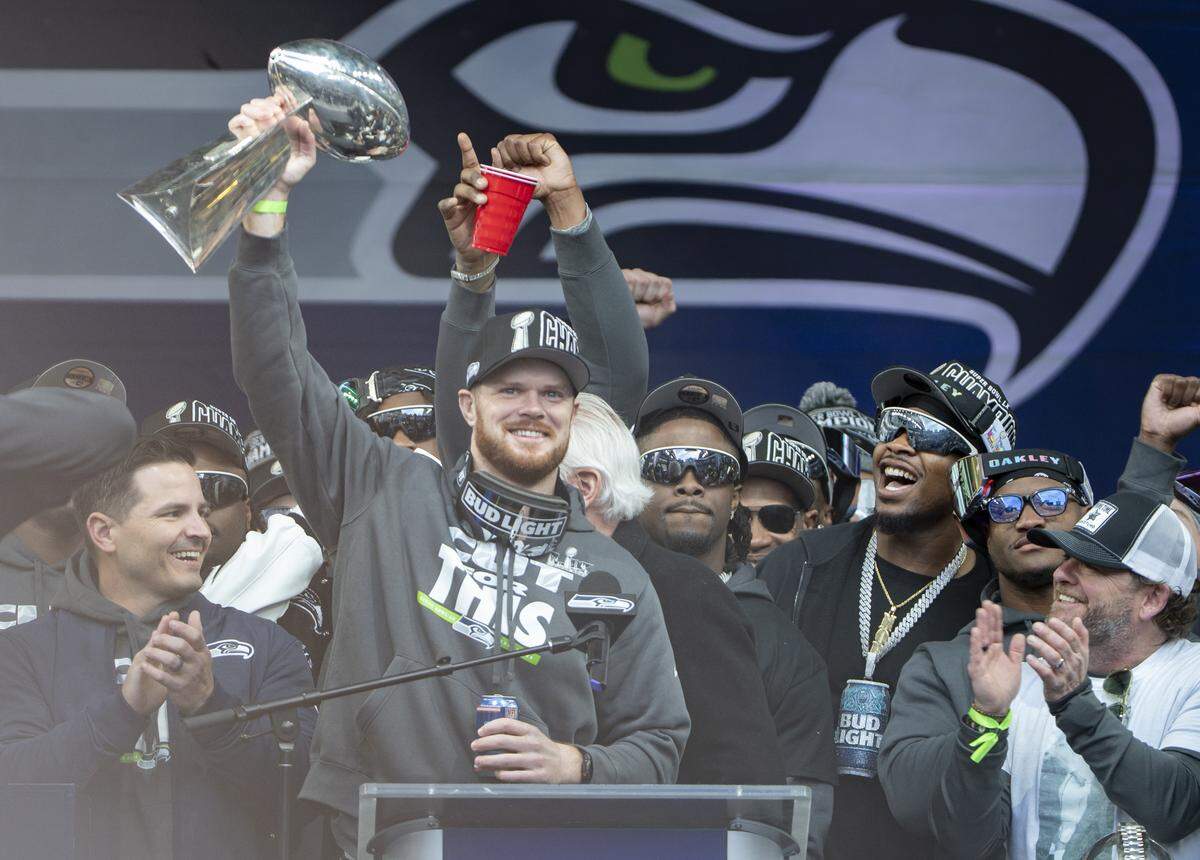 Seattle Seahawks quarterback Sam Darnold raises the Lombardi Trophy during the team’s Trophy Celebration event at Lumen Field on Wednesday, Feb. 11, 2026, in Seattle.