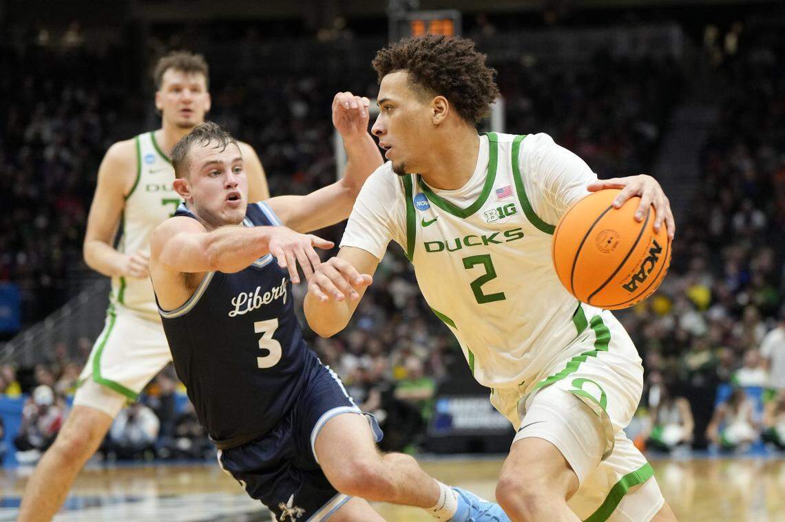 Mar 21, 2025; Seattle, WA, USA; Oregon Ducks guard Jadrian Tracey (2) dribbles the ball against Liberty Flames guard Kaden Metheny (3) during the first half in the first round of the NCAA Tournament  at Climate Pledge Arena. Mandatory Credit: Stephen Brashear-Imagn Images