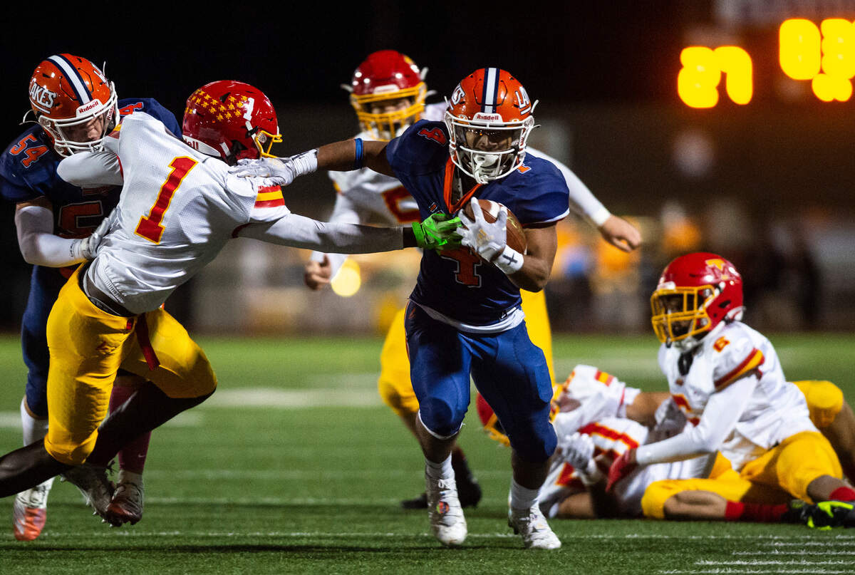 Lakes running back Ki’Marree Washington, 4, shoves Mount Tahoma safety Jukiry Bell, 1, as he runs down the field with the ball in the second quarter of a Thursday night game at Harry E. Lang Stadium in Lakewood, Wash. on Oct. 27, 2022. Lakes defeated Mount Tahoma 51-14.