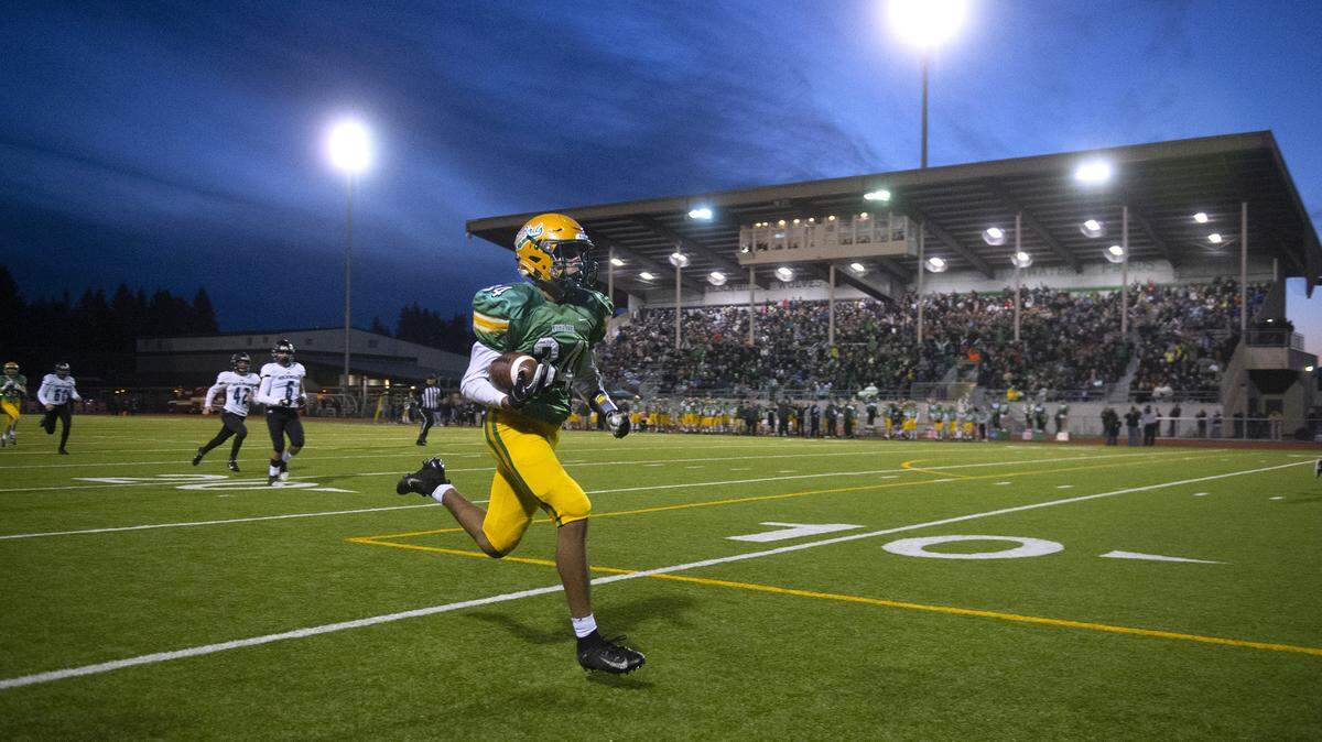 Tumwater kick returner Jayden Clay takes a punt all the way to the end zone during Saturday’s 2A state football semifinal game against the Hockinson Hawks at Tumwater District Stadium on Nov. 30, 2019. The touchdown was called back because of a T-Bird penalty.
